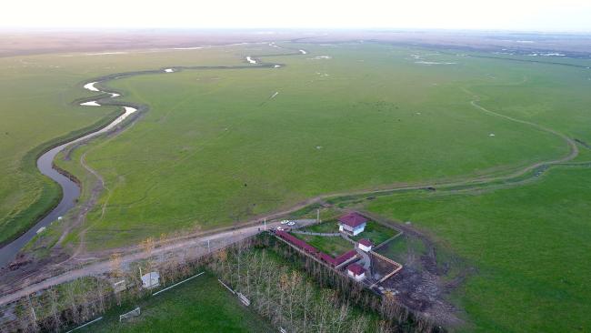 South east area of Anzali Wetland. Keshurud River,pasture (seasonal wetland) and reed bed of Chokum Wildlife Refuge are seen. The building with red roof is Anzali Wetland Eco Tourism Center. 