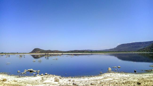 Calm lake overlooking the hills in the horizon
