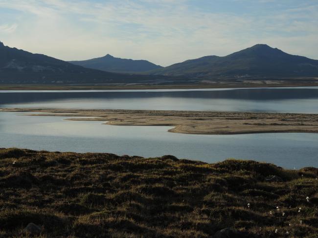 The bay seen from south and a coastal lagoon in front.