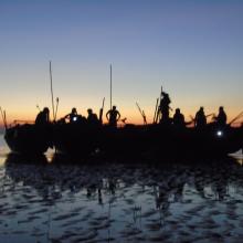 Survey team and boats at dusk